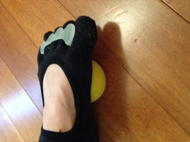 foot on a yoga tune up ball